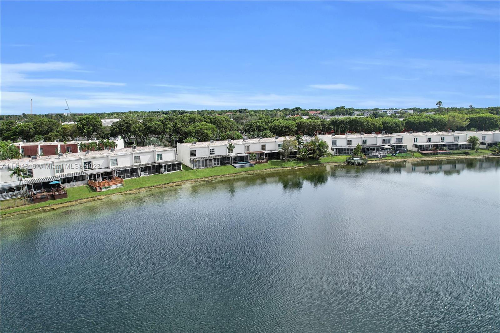 14001 Southwest 84th Street, Unit 1308 Miami, FL 33183 - Photo 42 of 47 a view of a lake with houses in the back