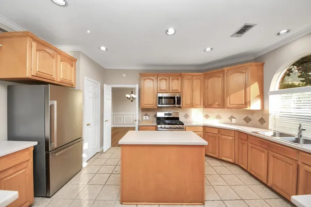 a kitchen with stainless steel appliances a stove sink microwave and cabinets