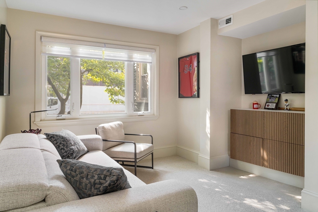 8 Naples Road, Unit 1 Brookline, MA 02446 - Photo 25 of 38 a living room with furniture and a flat screen tv