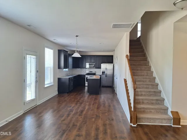 a view of a kitchen with sink and wooden floor