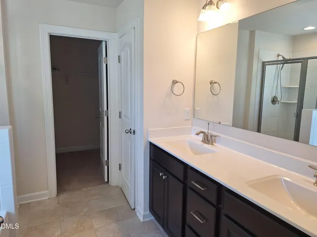 a bathroom with a double vanity sink mirror and double