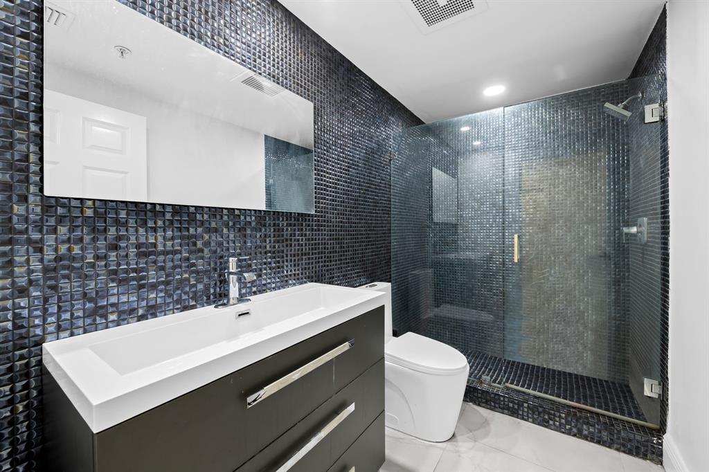 456 East Boca Raton Road Boca Raton, FL 33432 - Photo 7 of 24 a bathroom with a sink a toilet and shower