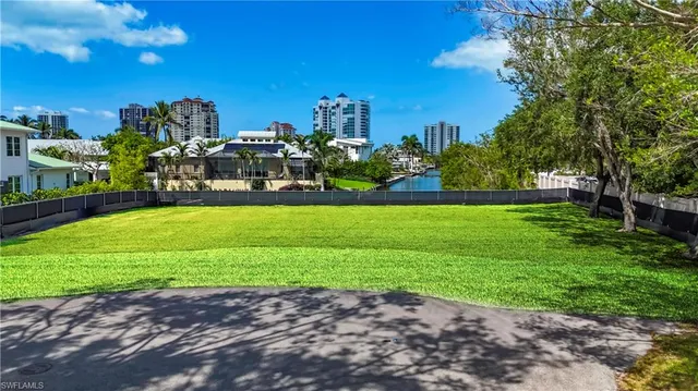 a view of a garden with a building in the background