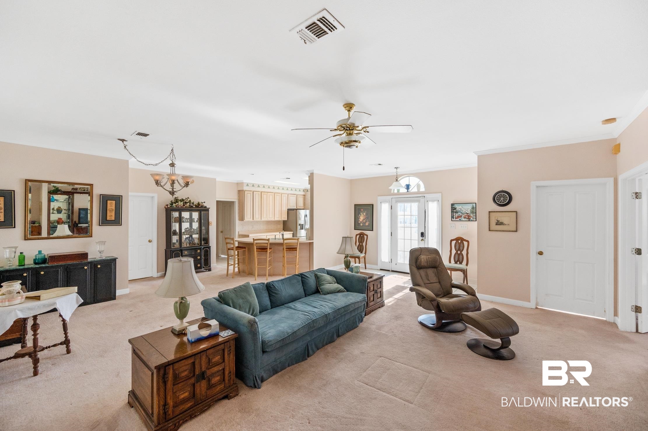 9260 Bay Point Drive Elberta, AL 36530 - Photo 6 of 34 Carpeted living room featuring ceiling fan with notable chandelier and ornamental molding