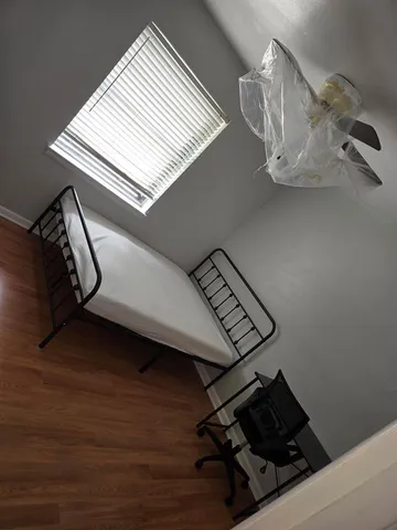 a view of gym equipment with wooden floor