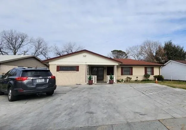 a view of a car parked in front of a house