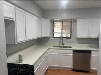 a kitchen with a sink cabinets and window