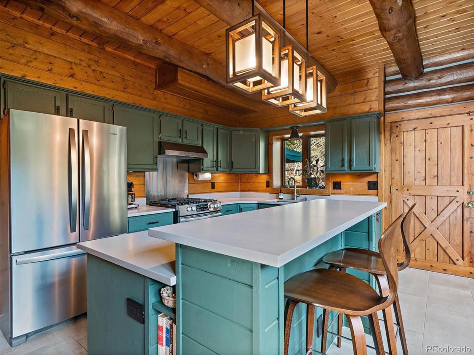 3602 Riverside Drive Lyons, CO 80540 - Photo 12 of 40 a kitchen with stainless steel appliances granite countertop a refrigerator a stove and a sink
