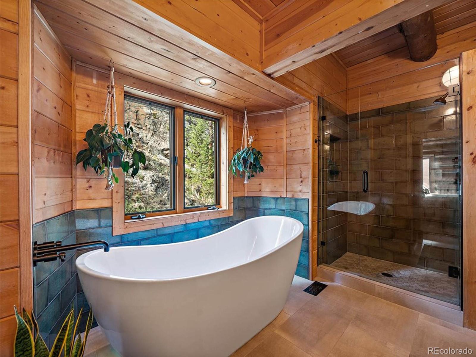 3602 Riverside Drive Lyons, CO 80540 - Photo 16 of 40 a bathroom with a bathtub and shower