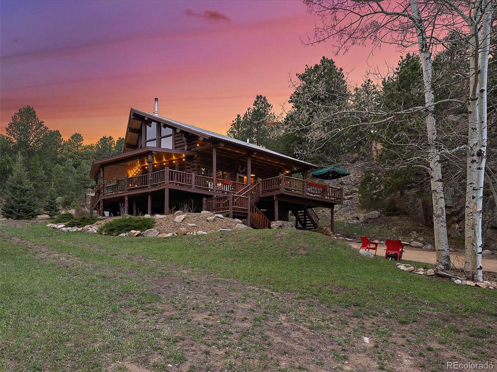 3602 Riverside Drive Lyons, CO 80540 - Photo 2 of 40 a front view of a house with a yard