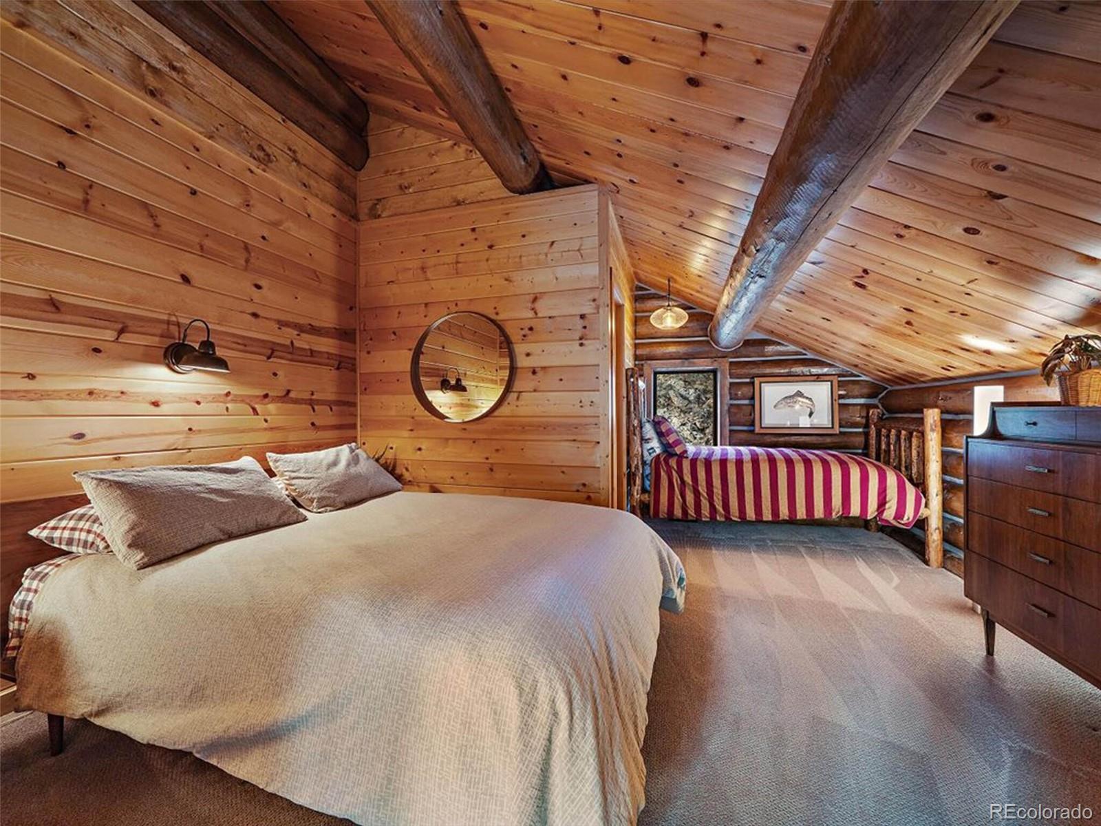 3602 Riverside Drive Lyons, CO 80540 - Photo 25 of 40 a bedroom with a bed and a large window