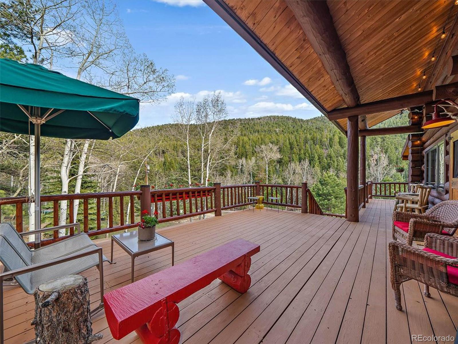 3602 Riverside Drive Lyons, CO 80540 - Photo 28 of 40 a balcony with wooden floor table and chairs