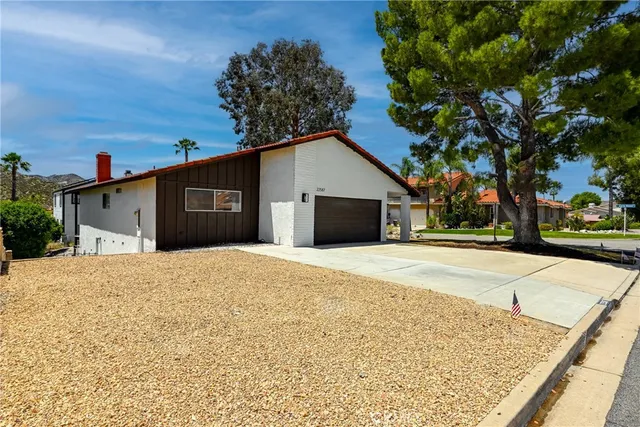 a view of a house with a yard and garage