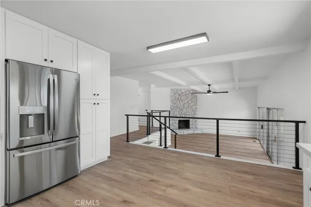 a view of kitchen with furniture and stainless steel appliances