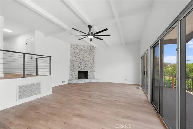 wooden floor in an empty room with a fireplace