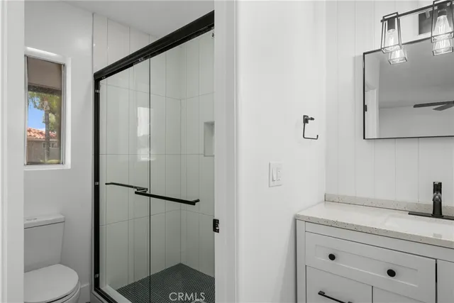 a bathroom with a shower toilet and sink