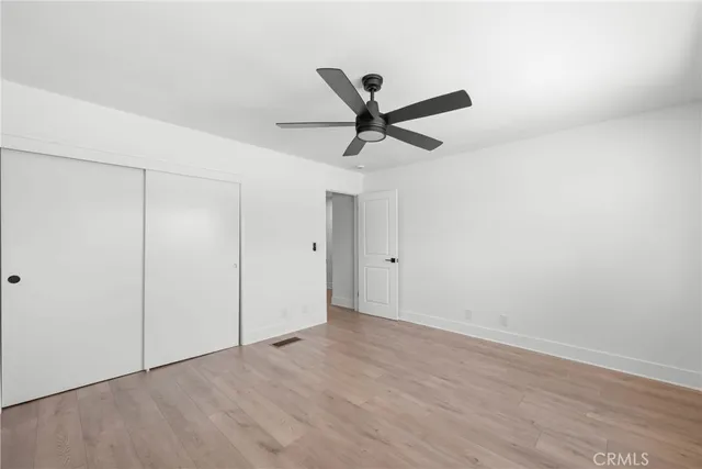 a view of a ceiling fan and hardwood floor