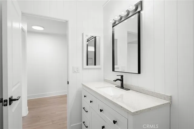 a bathroom with a sink vanity and mirror
