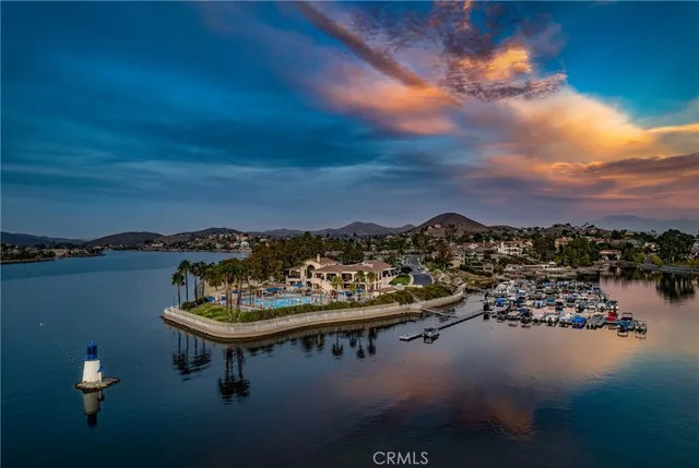 a view of a lake with lawn chairs
