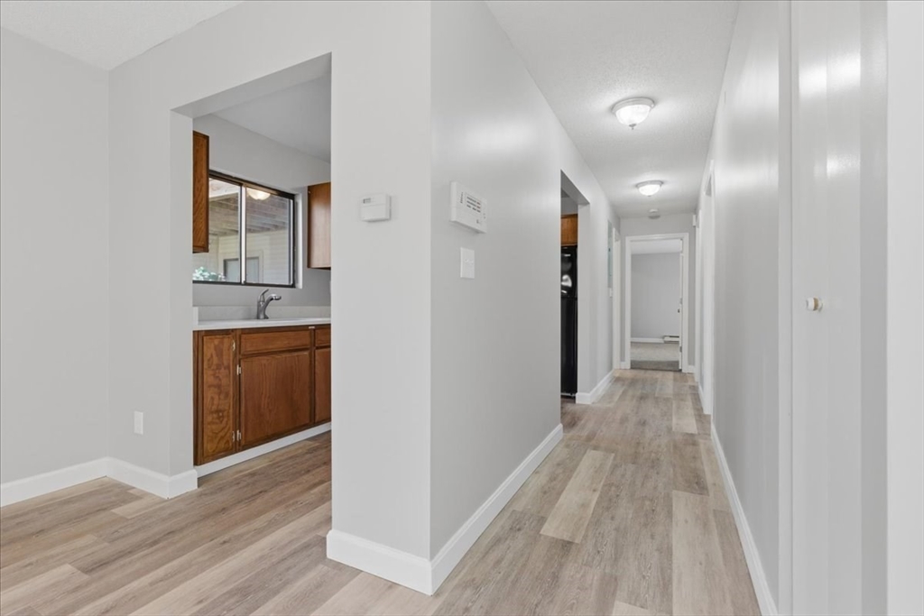 800 Bearses Way, Unit 2SB Barnstable, MA 02601 - Photo 15 of 40 a view of a hallway with wooden floor