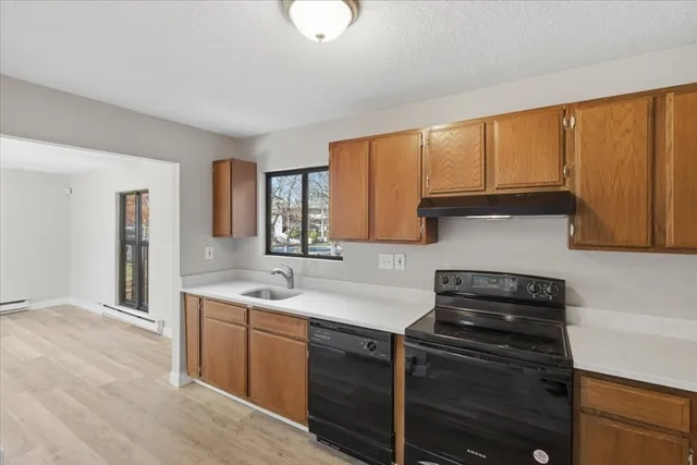 a kitchen with a refrigerator and a sink