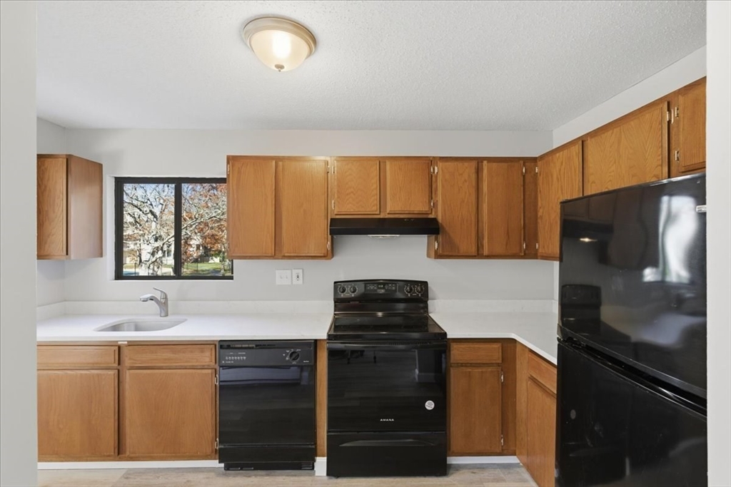 800 Bearses Way, Unit 2SB Barnstable, MA 02601 - Photo 17 of 40 a kitchen with a refrigerator and a sink