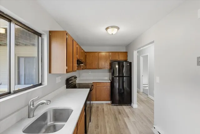 a kitchen with a sink a refrigerator and window