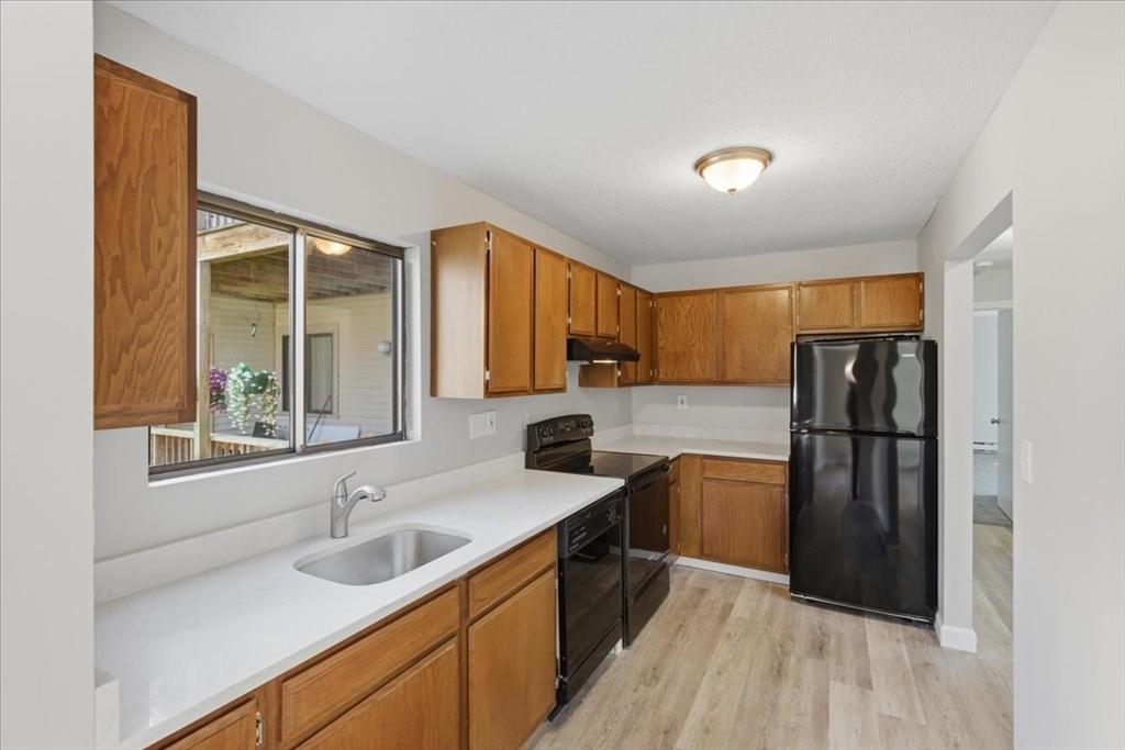 800 Bearses Way, Unit 2SB Barnstable, MA 02601 - Photo 20 of 40 a kitchen with a sink a refrigerator and window