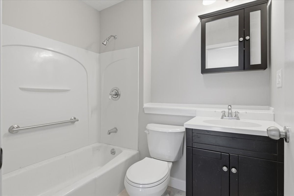 800 Bearses Way, Unit 2SB Barnstable, MA 02601 - Photo 29 of 40 a bathroom with a toilet a sink a mirror a bathtub and vanity