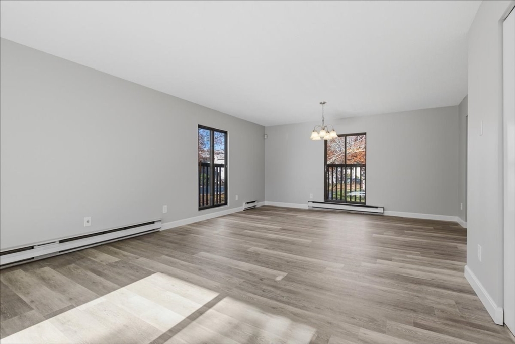 800 Bearses Way, Unit 2SB Barnstable, MA 02601 - Photo 9 of 40 wooden floor in an empty room with a window