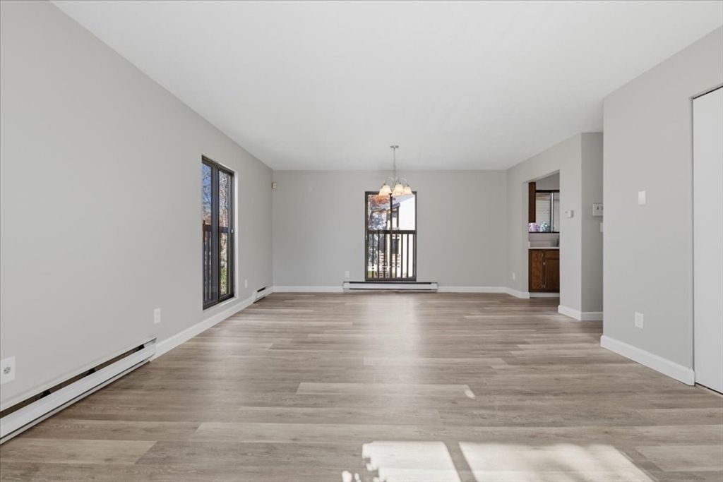 800 Bearses Way, Unit 2SB Barnstable, MA 02601 - Photo 10 of 40 a view of empty room with wooden floor and fan
