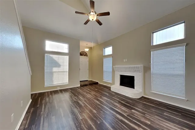 a view of an empty room with exposed radiator and fireplace