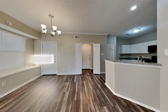 a view of a kitchen with a sink and dishwasher a refrigerator with wooden floor