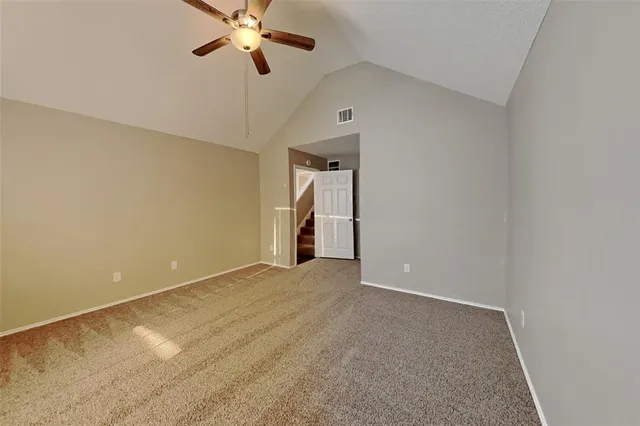 a view of empty room with a ceiling fan