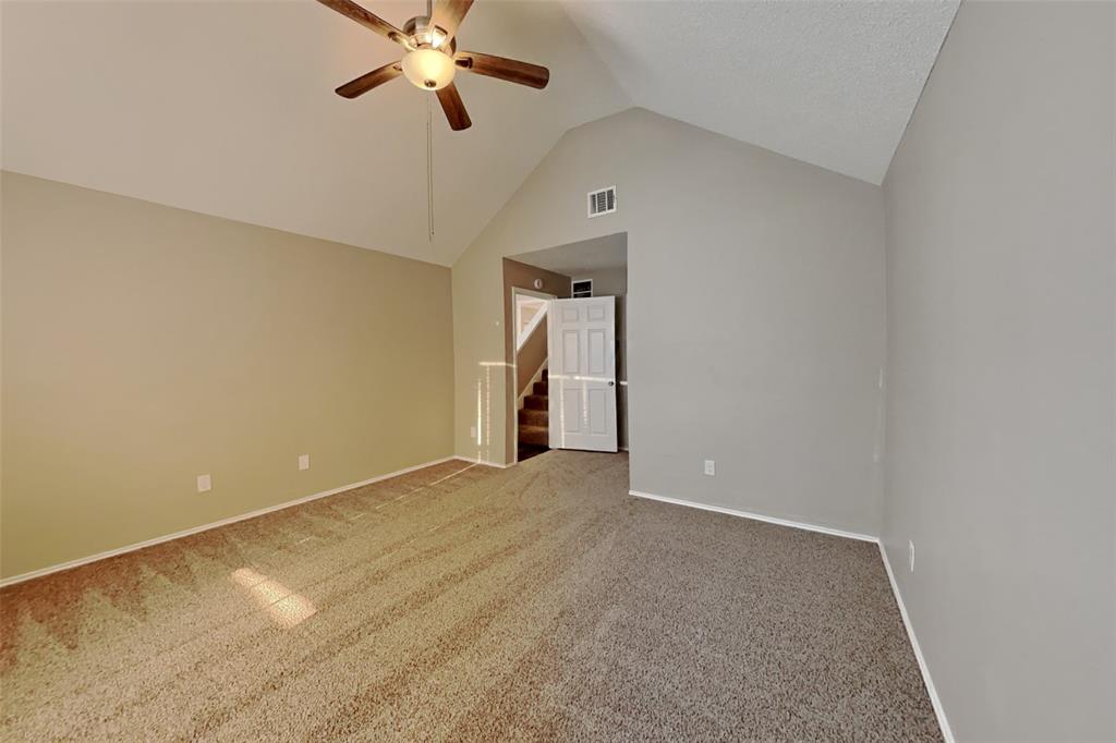 921 Mossberg Lane Mesquite, TX 75181 - Photo 7 of 17 Empty room featuring ceiling fan, carpet flooring, high vaulted ceiling, and stairway