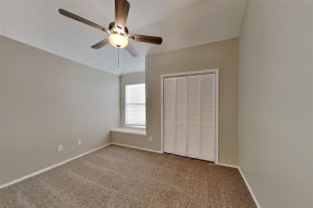 921 Mossberg Lane Mesquite, TX 75181 - Photo 9 of 17 Unfurnished bedroom with carpet, ceiling fan, a closet, and a textured ceiling