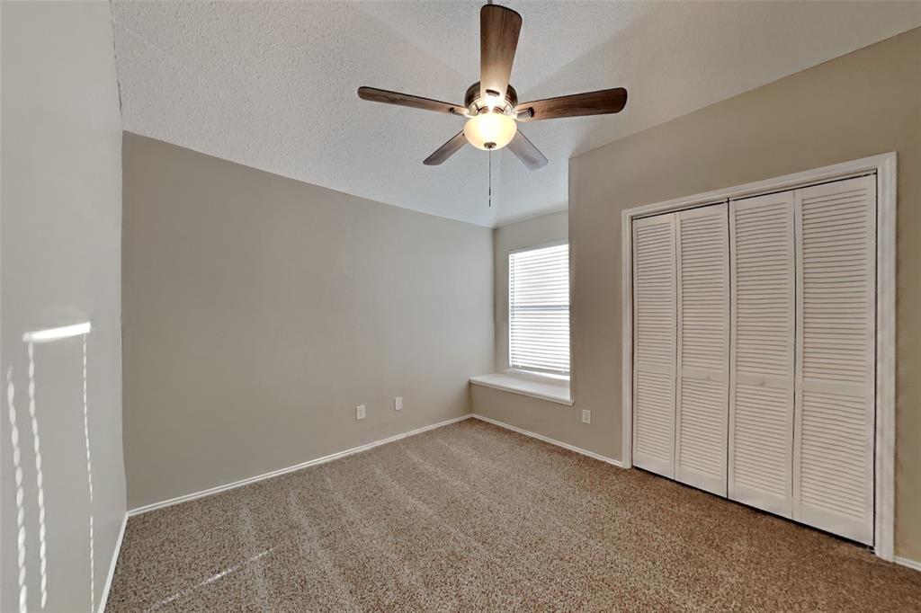 921 Mossberg Lane Mesquite, TX 75181 - Photo 10 of 17 Unfurnished bedroom featuring a textured ceiling, carpet, ceiling fan, and a closet
