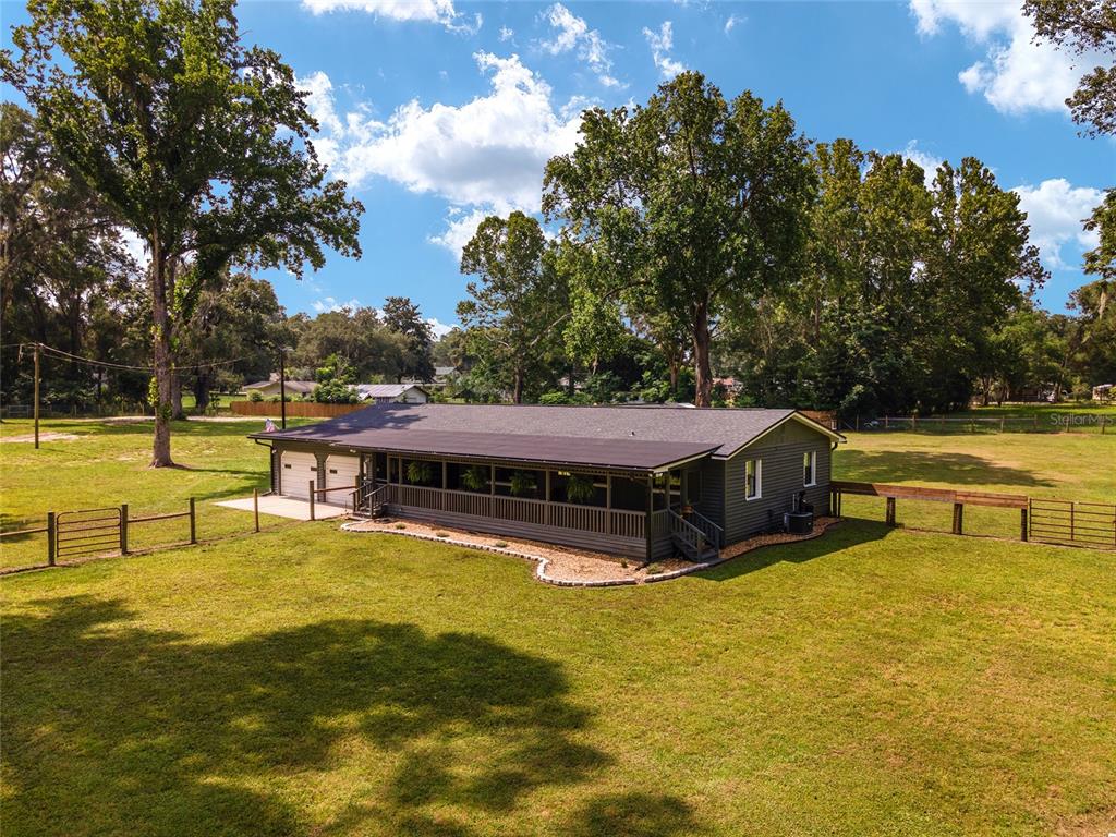 9 Northwest 59th Street Ocala, FL 34475 - Photo 1 of 1 a view of a swimming pool with lawn chairs under an umbrella