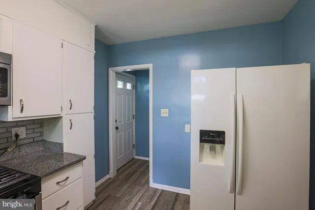 a kitchen with a refrigerator and sink