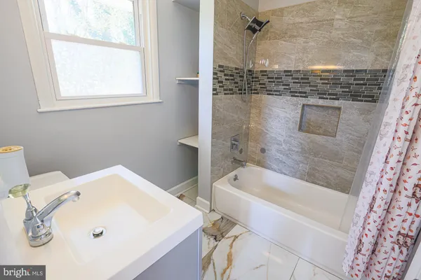 a bathroom with a tub and a sink