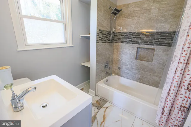 a bathroom with a tub and a sink