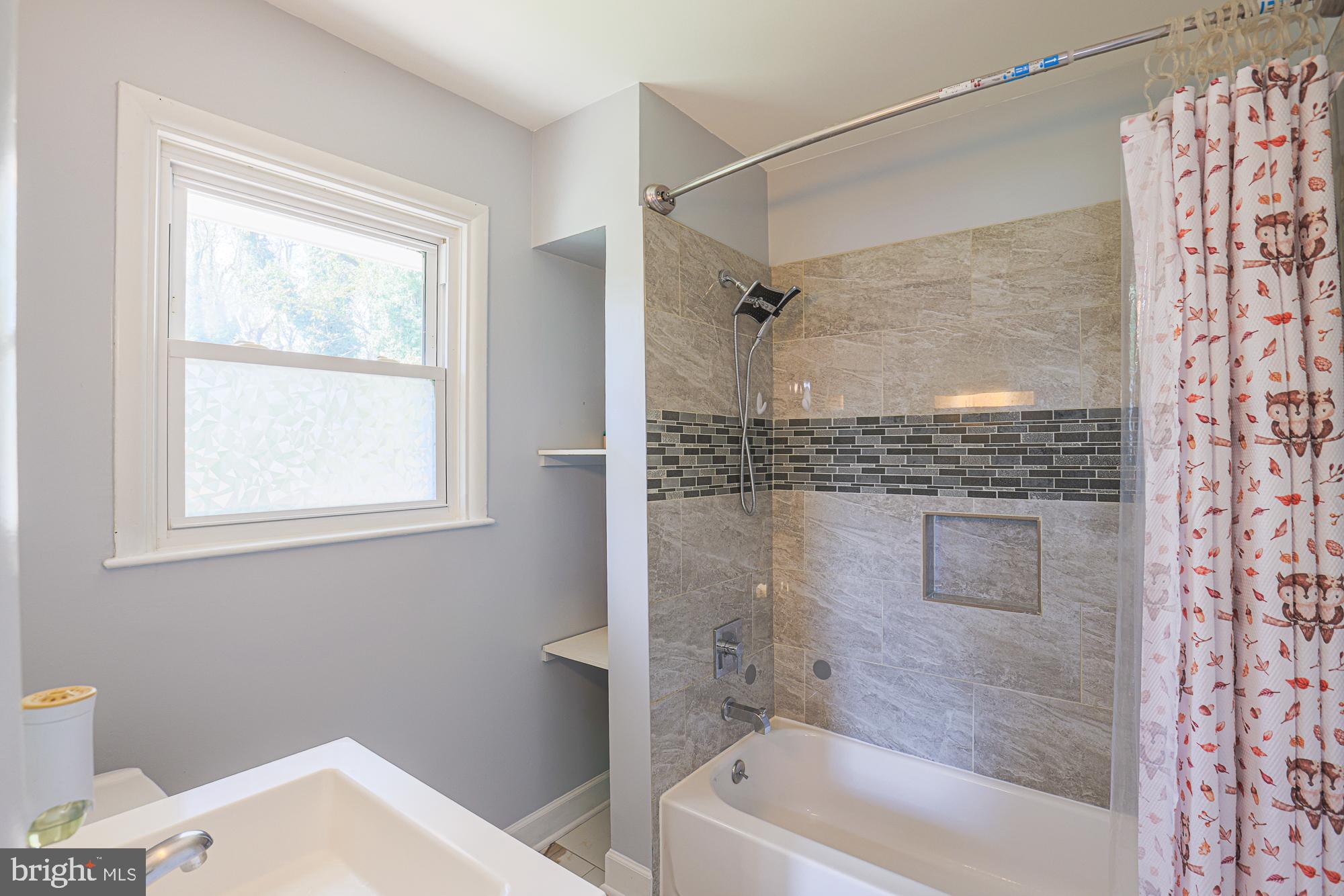 416 Nottingham Road Baltimore, MD 21229 - Photo 19 of 39 a bathroom with a bathtub and a shower