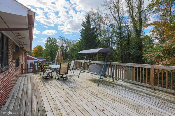 a view of house with deck and outdoor seating