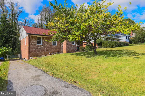 a front view of house with yard and outdoor seating