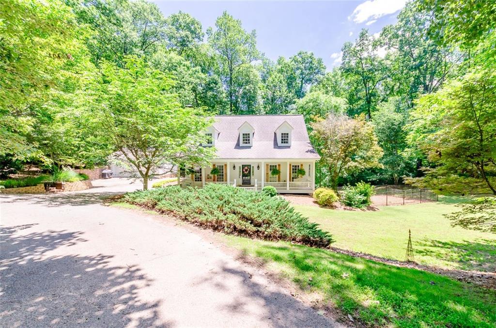 225 Bowman Mill Road Northeast Winder, GA 30680 - Photo 1 of 1 a front view of a house with a yard and a large tree