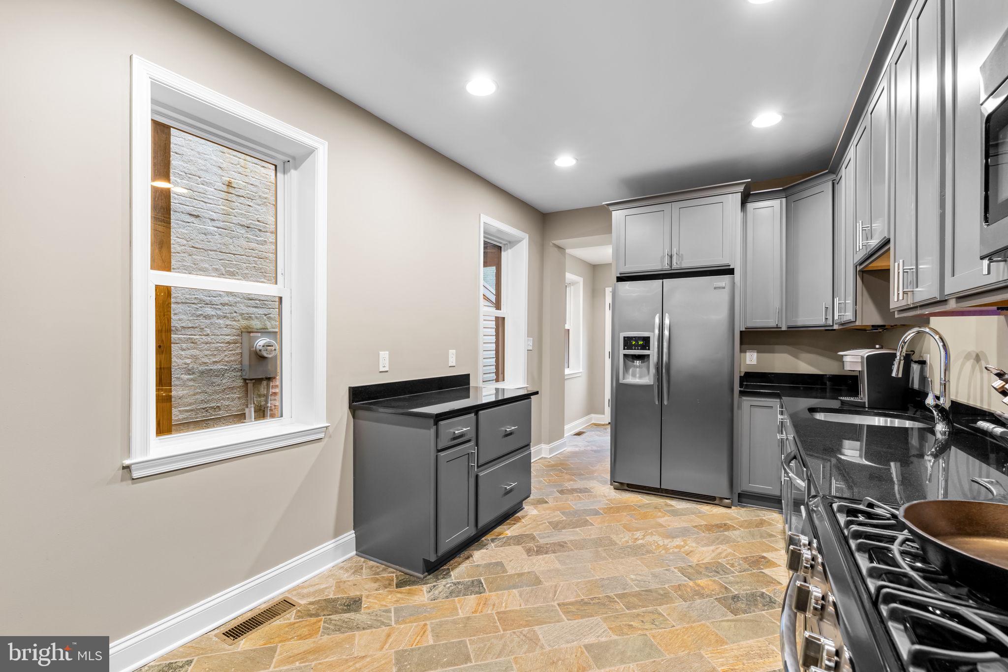 3116 Hudson Street Baltimore, MD 21224 - Photo 11 of 39 a kitchen with refrigerator a stove and a sink