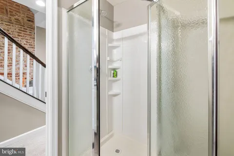 a bathroom with a shower and a door