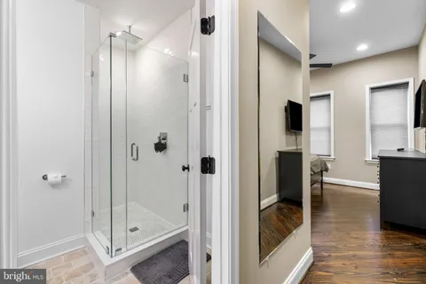 a bathroom with a shower and a glass door