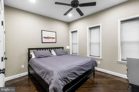 a bedroom with a large bed and a window