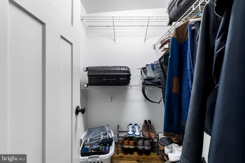a room with a washing machine and storage